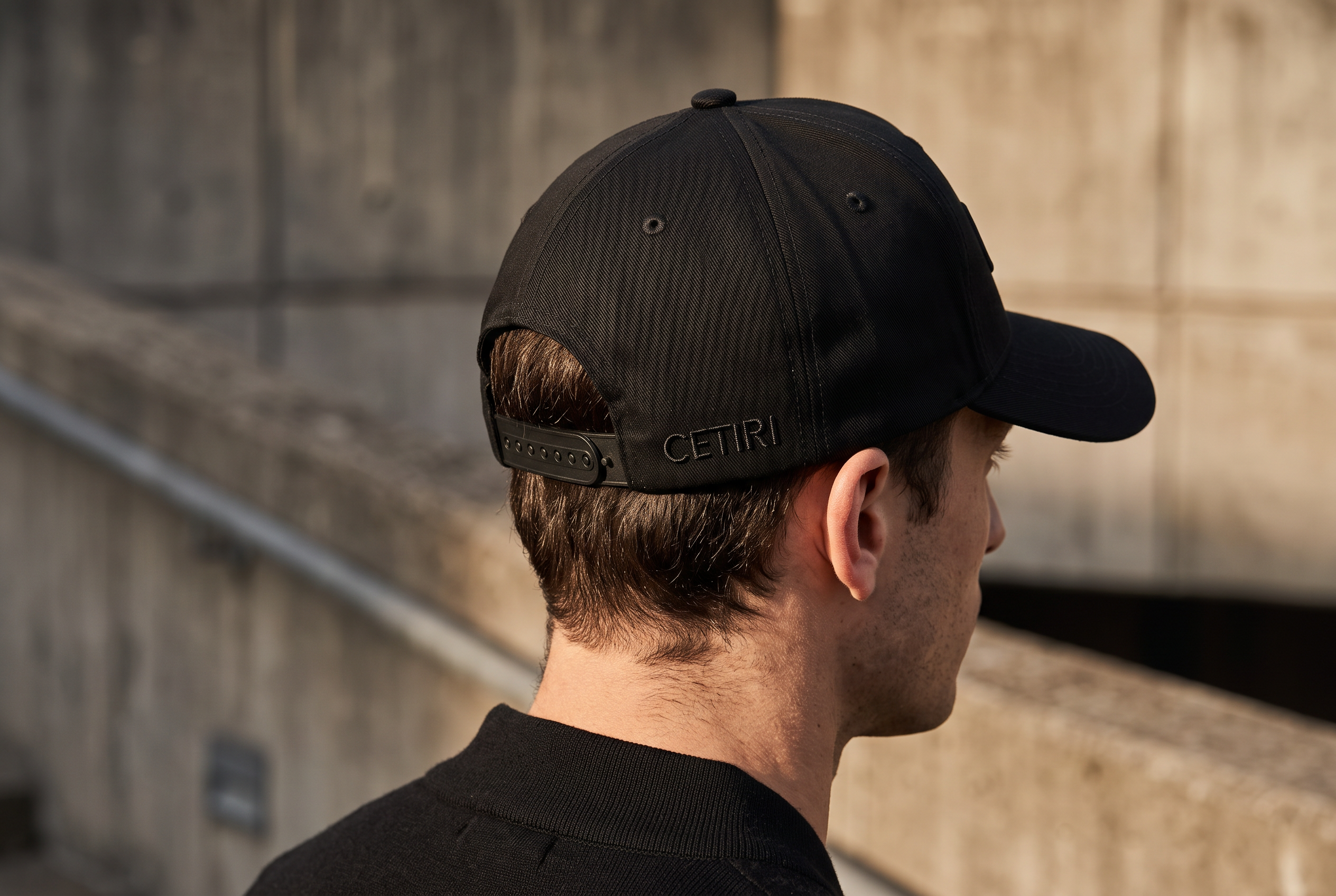 Detail of the black CETIRI cap in warm architectural light